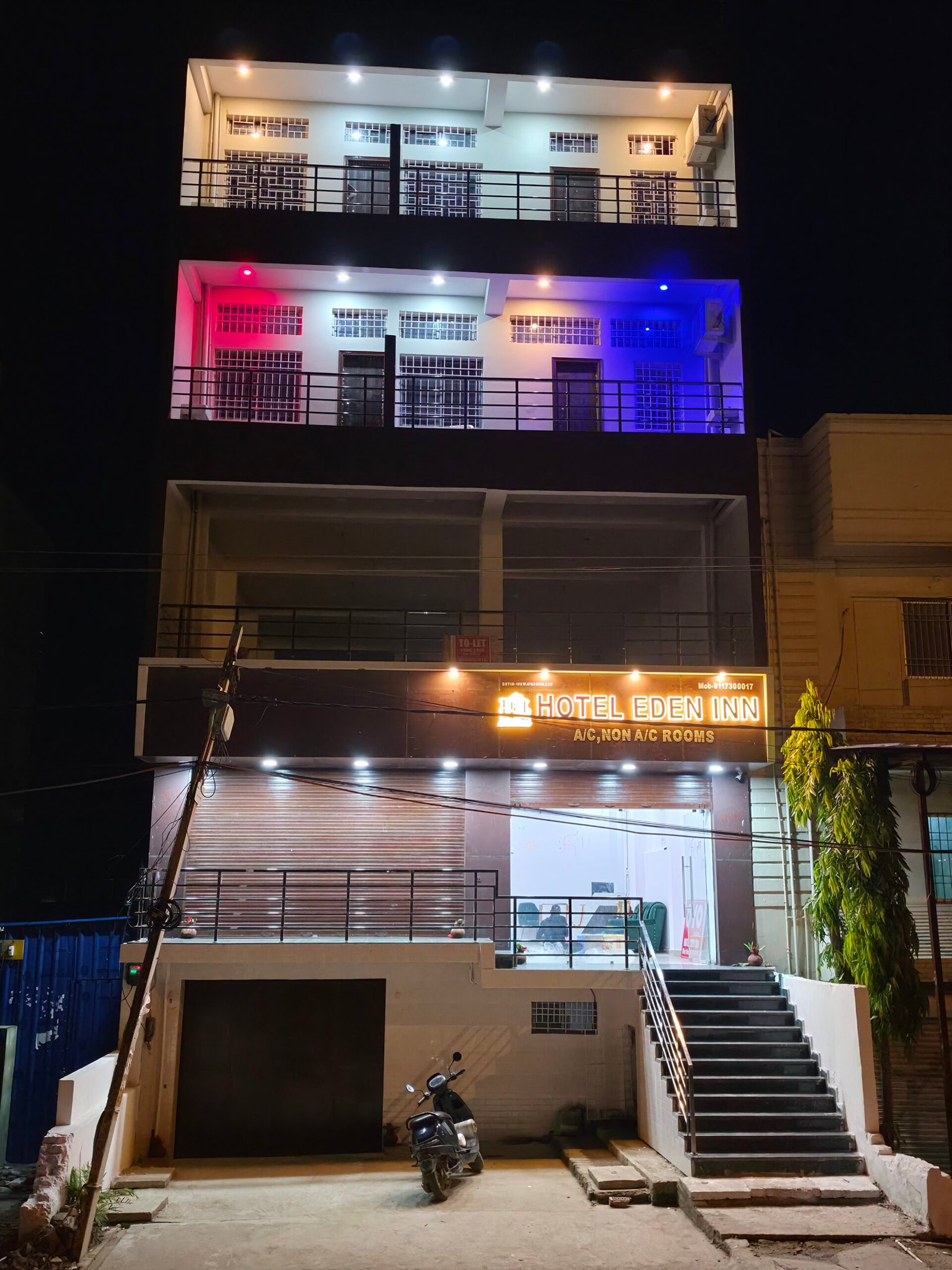 Hotel Eden Inn — well-lit facade at night, roadside bypass location